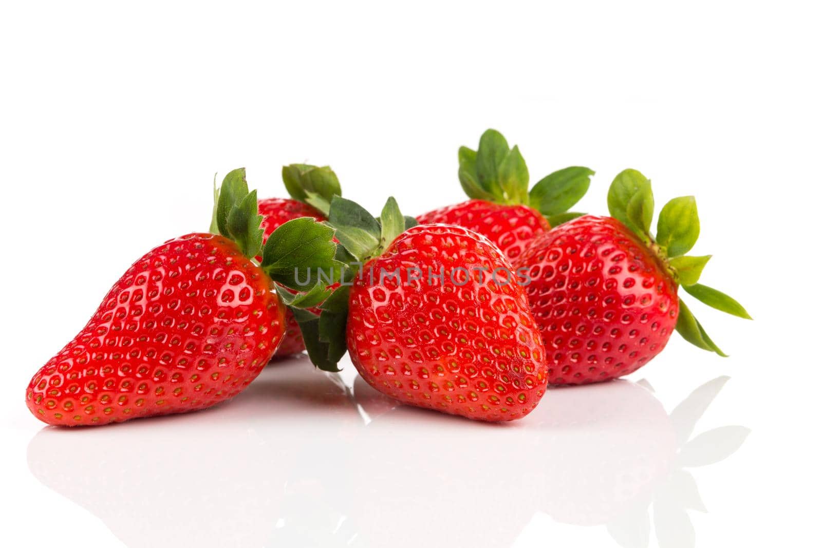 Red ripe strawberry fruits on a dark background