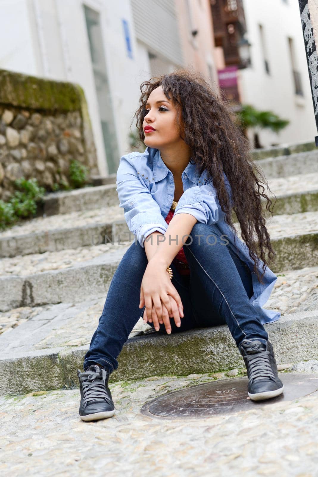Attractive mixed woman in urban background wearing casual clothes by javiindy