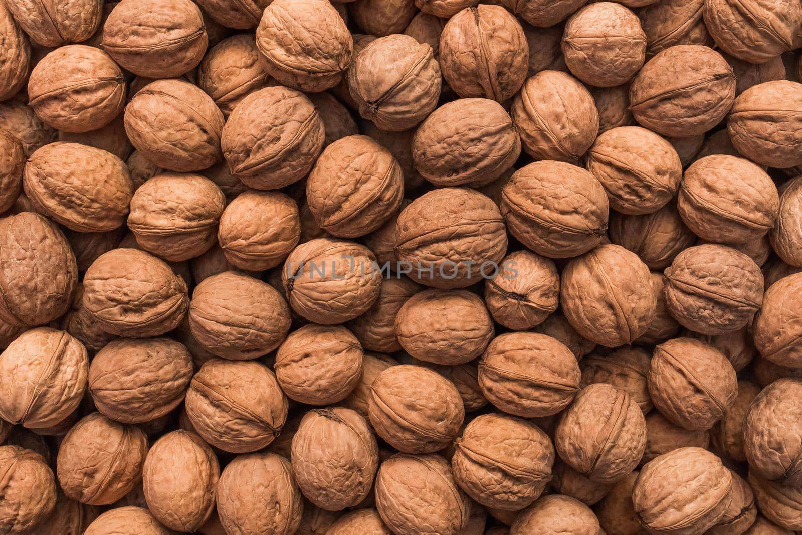 Walnuts ingredient texture, pile of nuts food snack background.