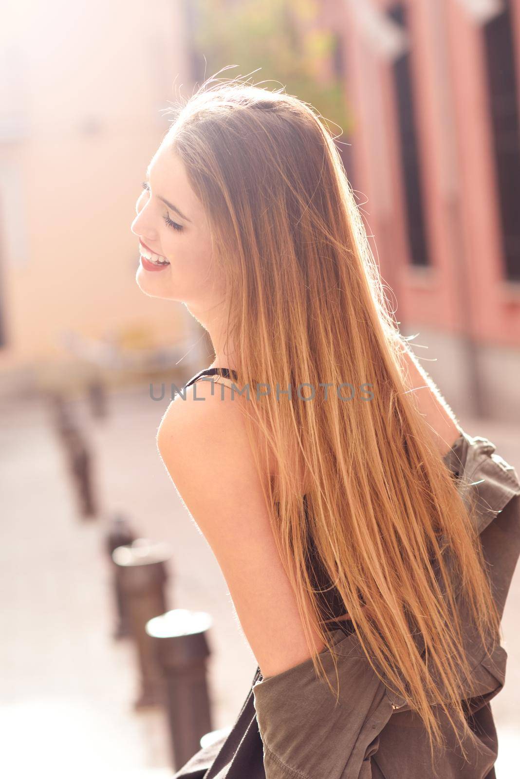 Portrait of young blonde girl wearing casual clothes in urban background