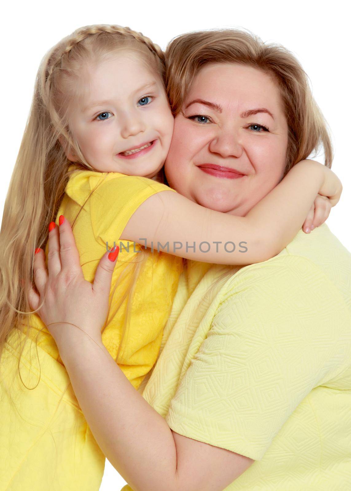 Young blonde mother, gently hugs her favorite little round-faced daughter. Family Idyll.Isolated on white background.