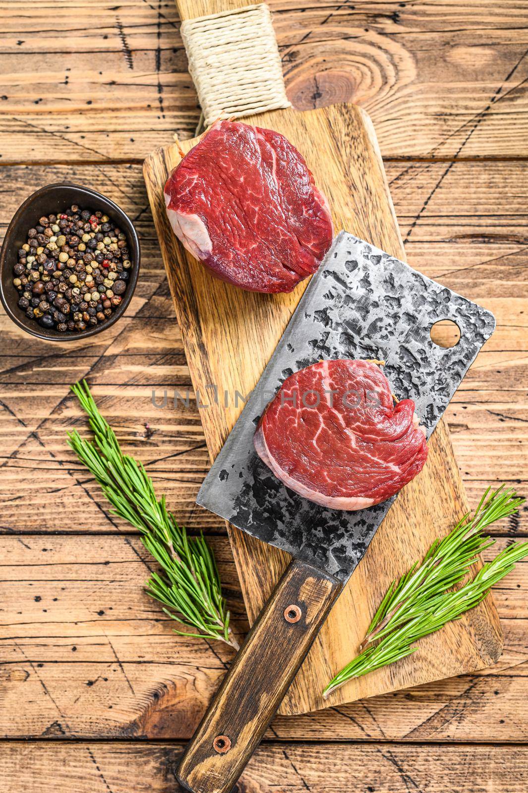 Raw fresh marbled meat Steak fillet mignon. Wooden background. Top view.