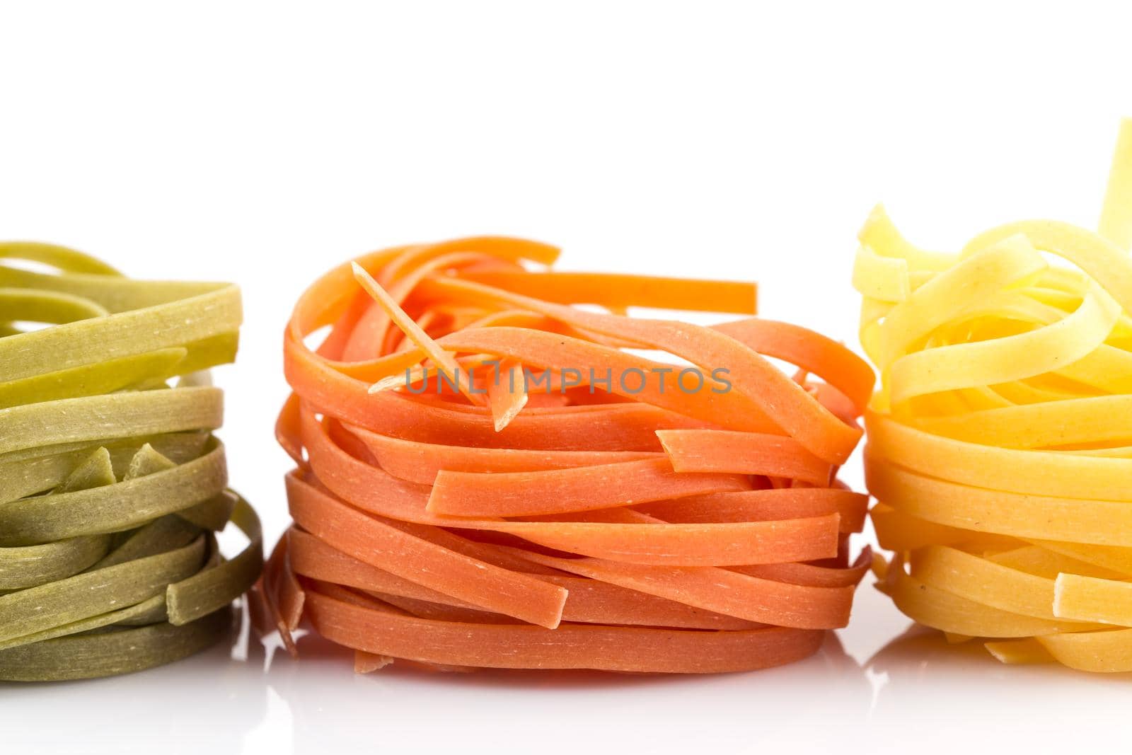 three colour roll nest pasta on a white background