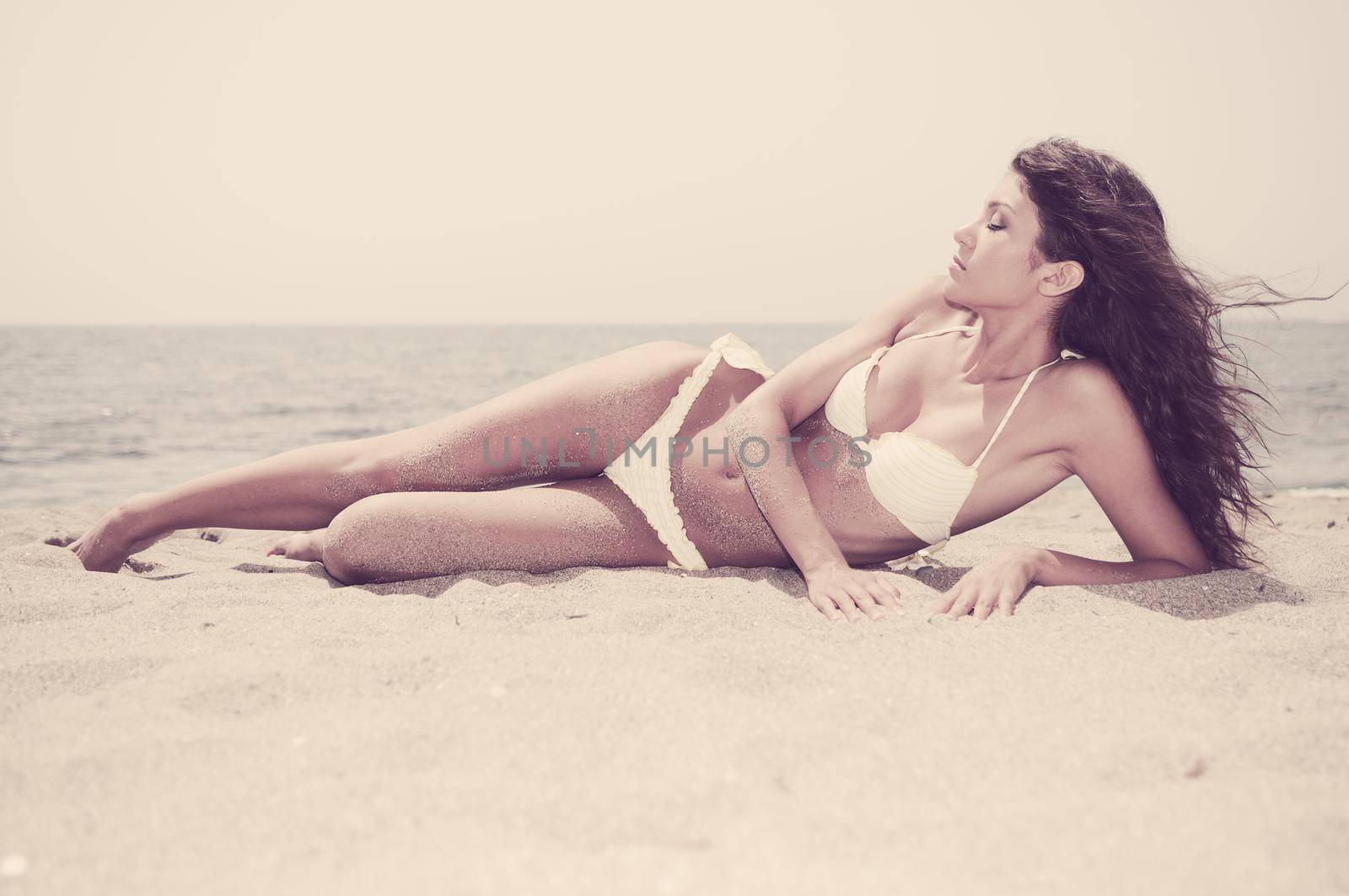 Portrait of a woman with beautiful body on a tropical beach