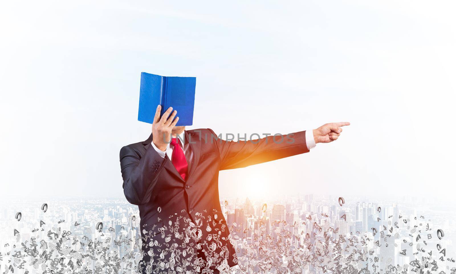 Businessman covered his face with organizer and finger pointing side. Man in business suit and tie standing on city background with flying various letters. Education and professional knowledges.