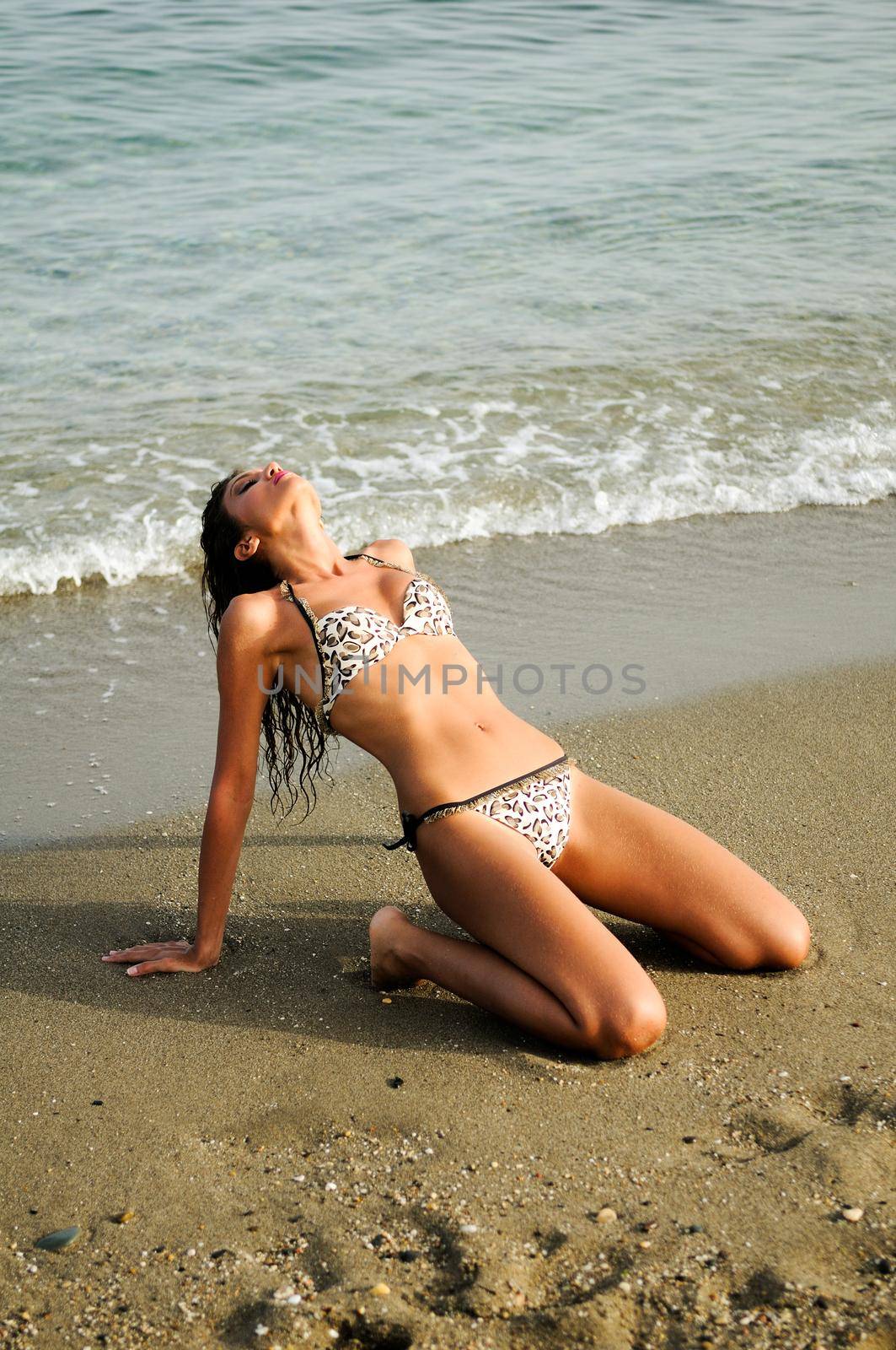 Portrait of a woman with beautiful body on a tropical beach