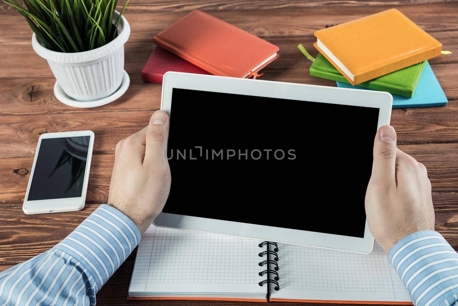 close-up of men's hands with a computer tablet. Businessman works in the office