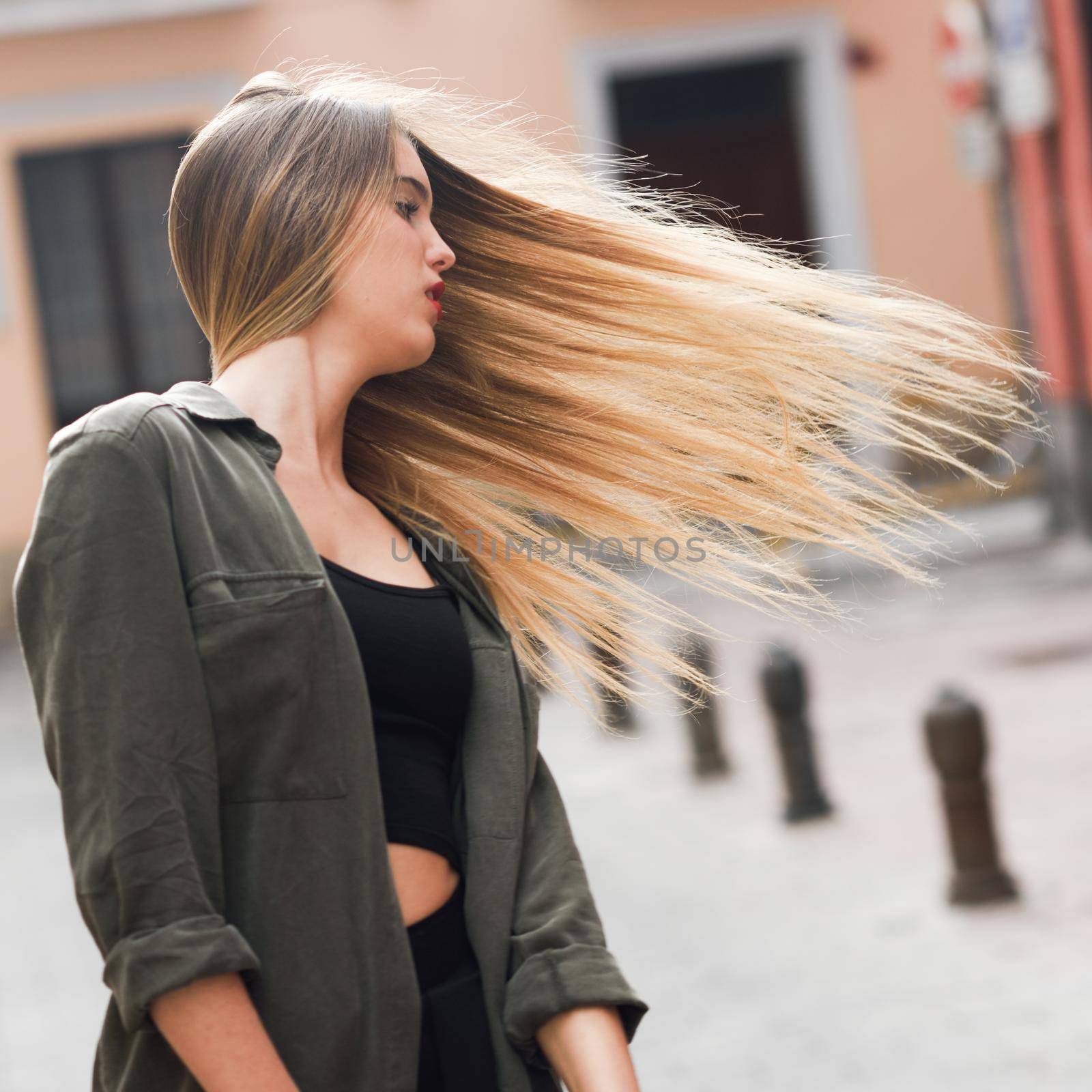 Portrait of blonde girl moving her amazing long hair