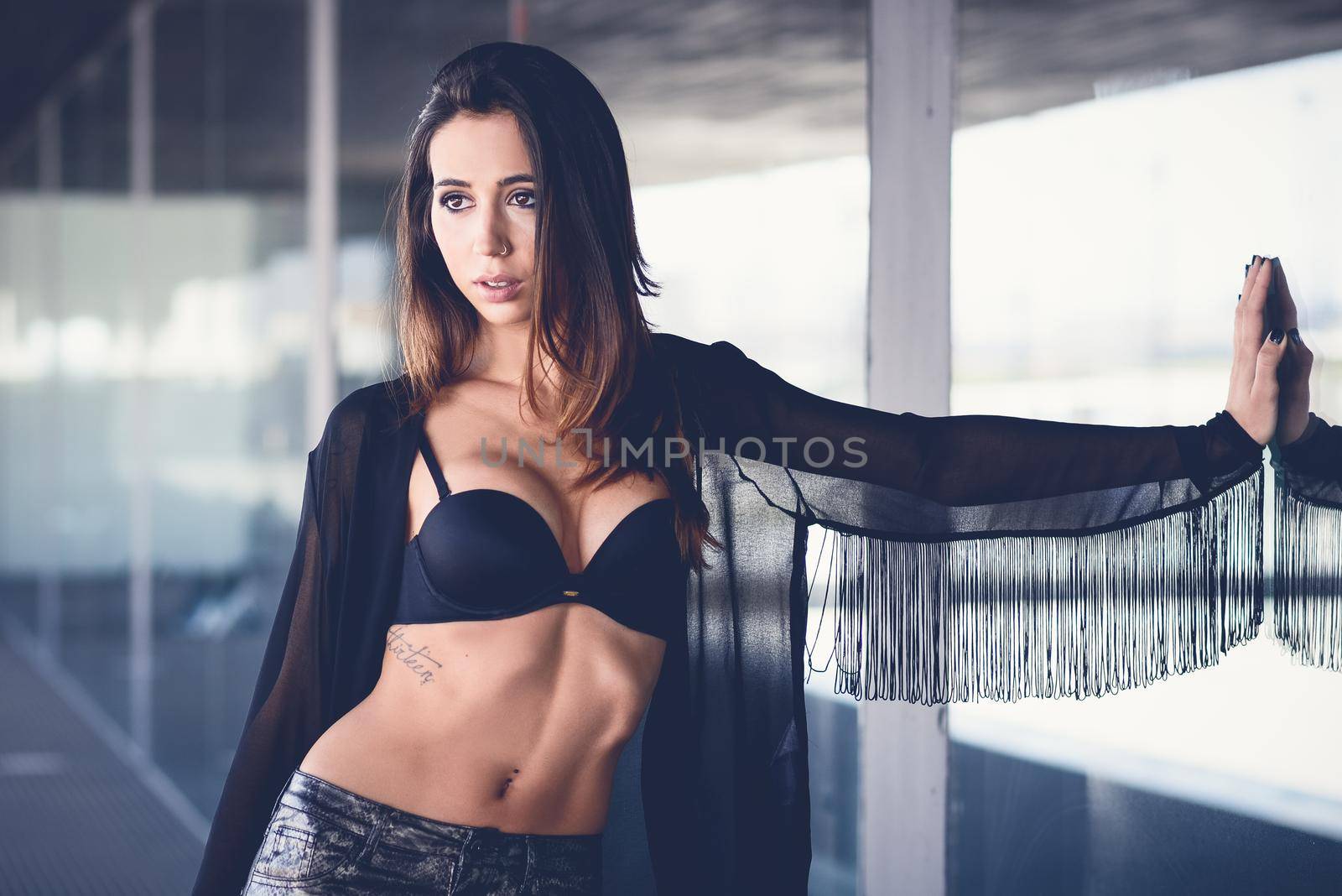 Portrait of young beautiful woman, model of fashion, wearing transparent shirt and black bra