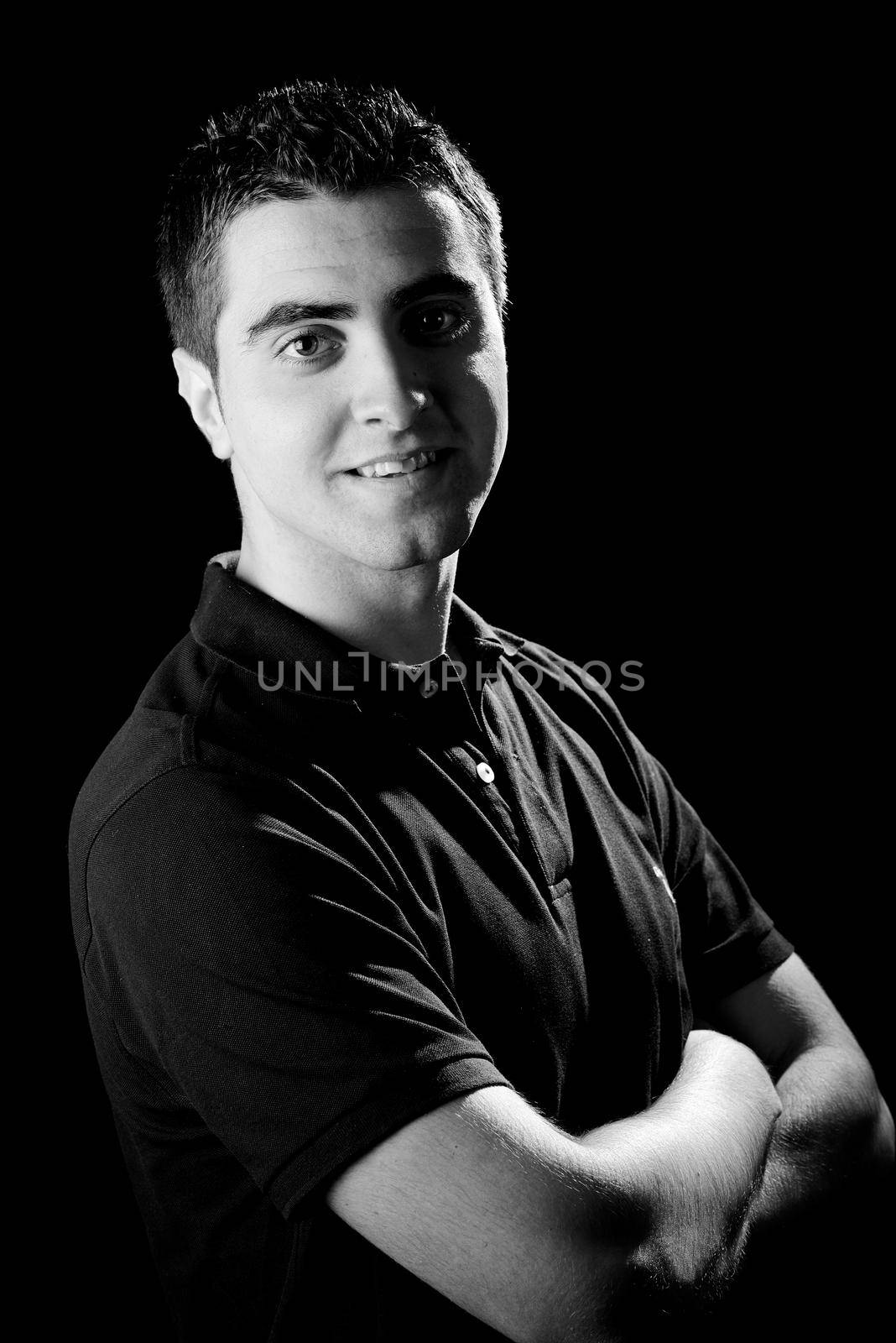 Portrait of a young casual man on black background