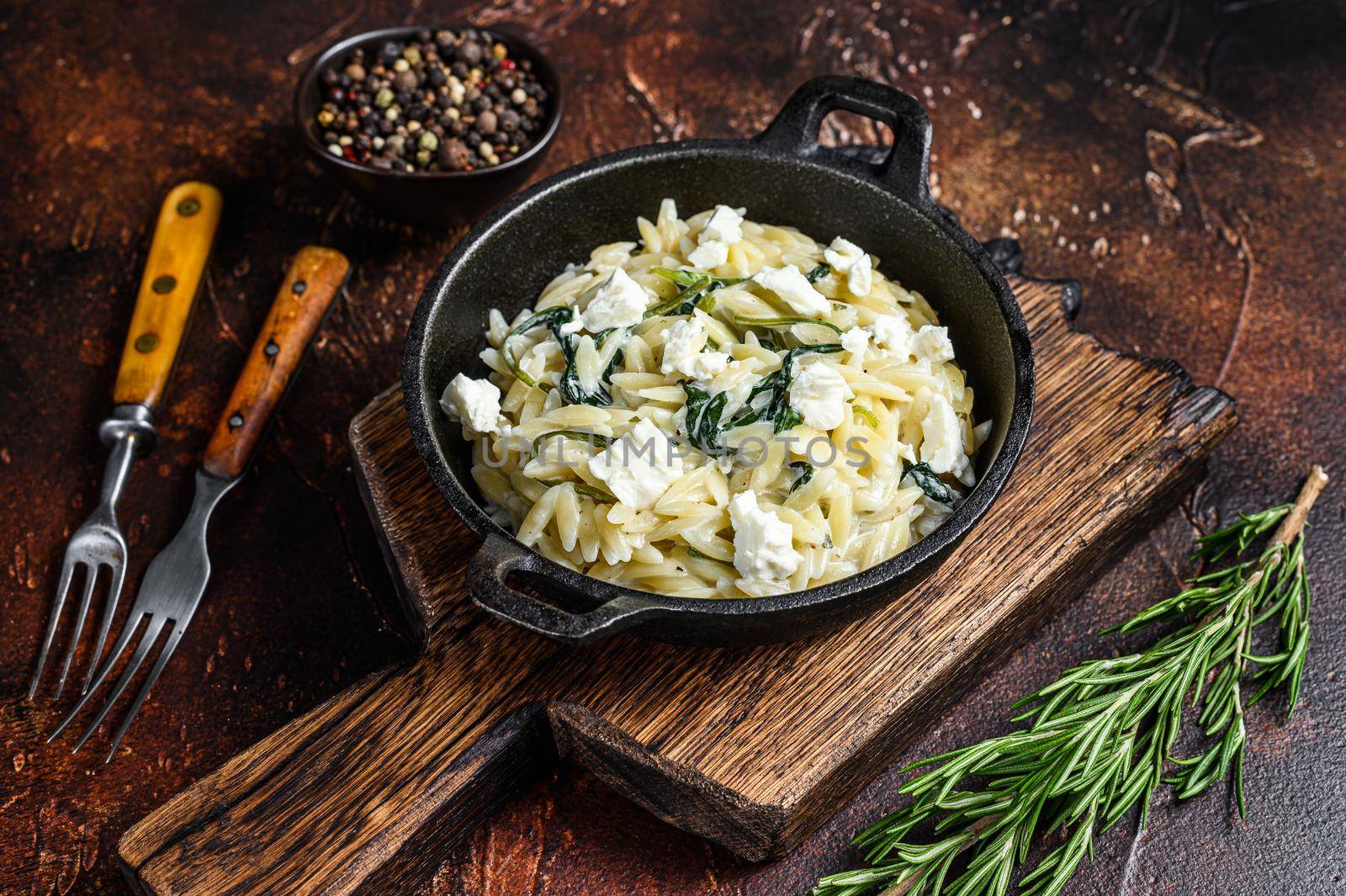 Orzo primavera with green veggies spinach. Dark wooden background. Top view by Composter