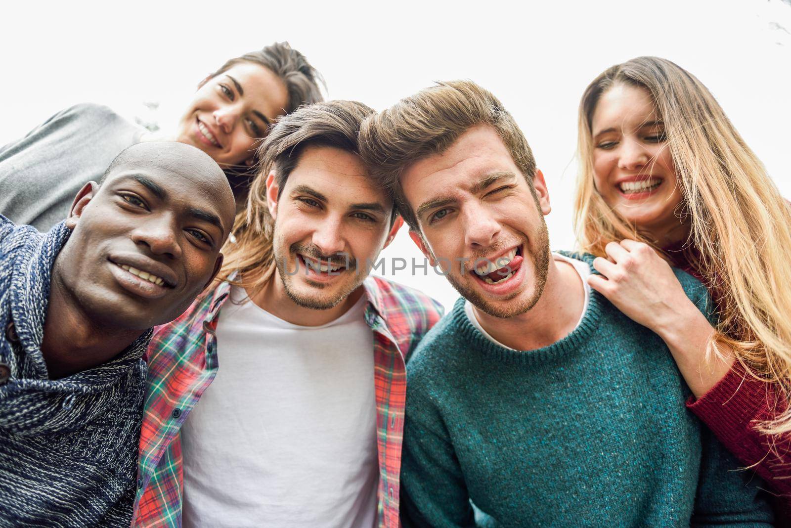 Multiracial group of friends taking selfie by javiindy
