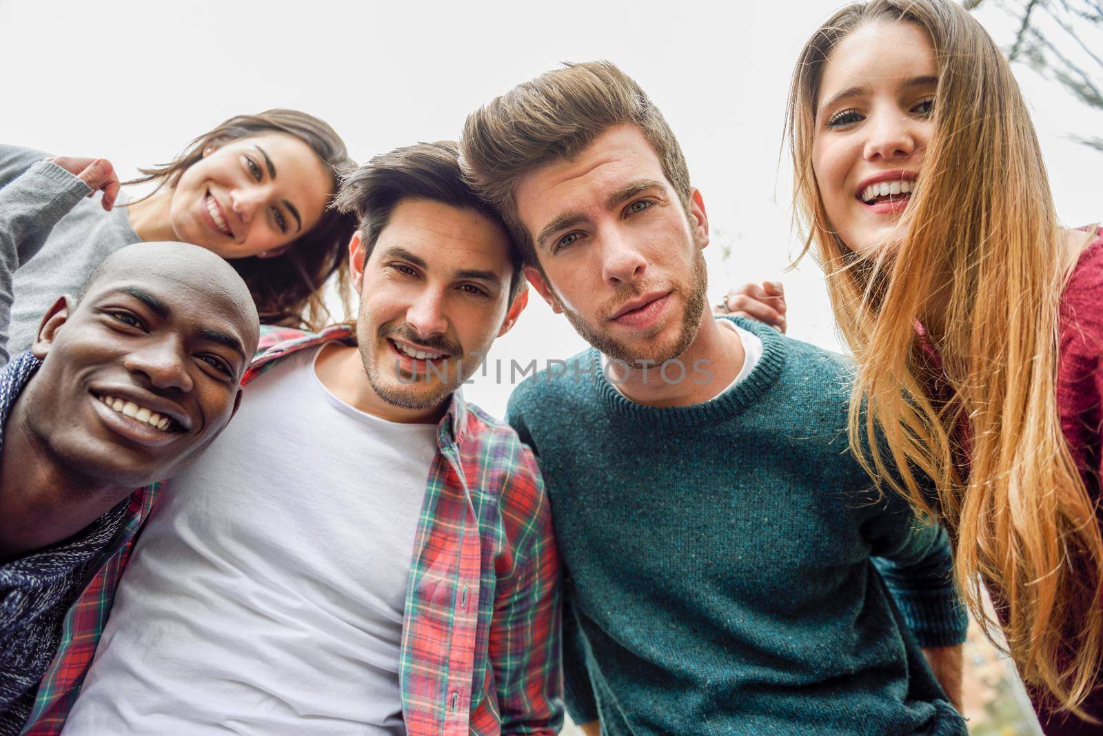 Multiracial group of friends taking selfie by javiindy