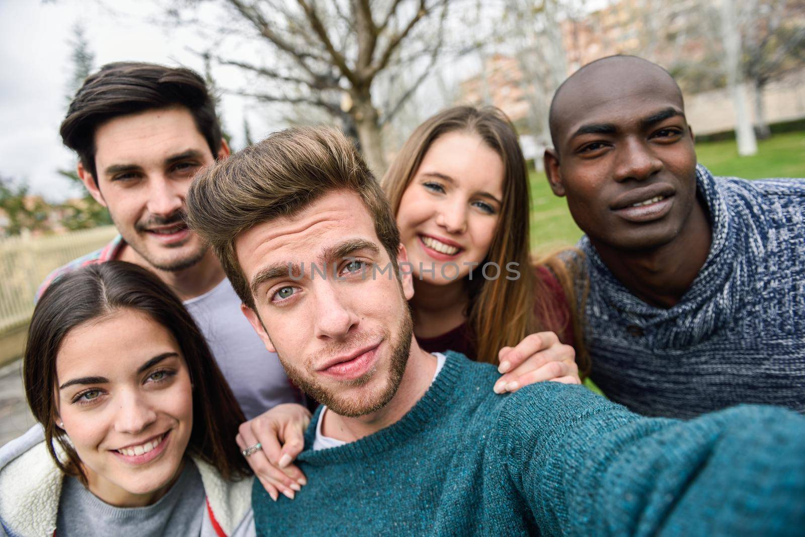 Multiracial group of friends taking selfie in a urban park