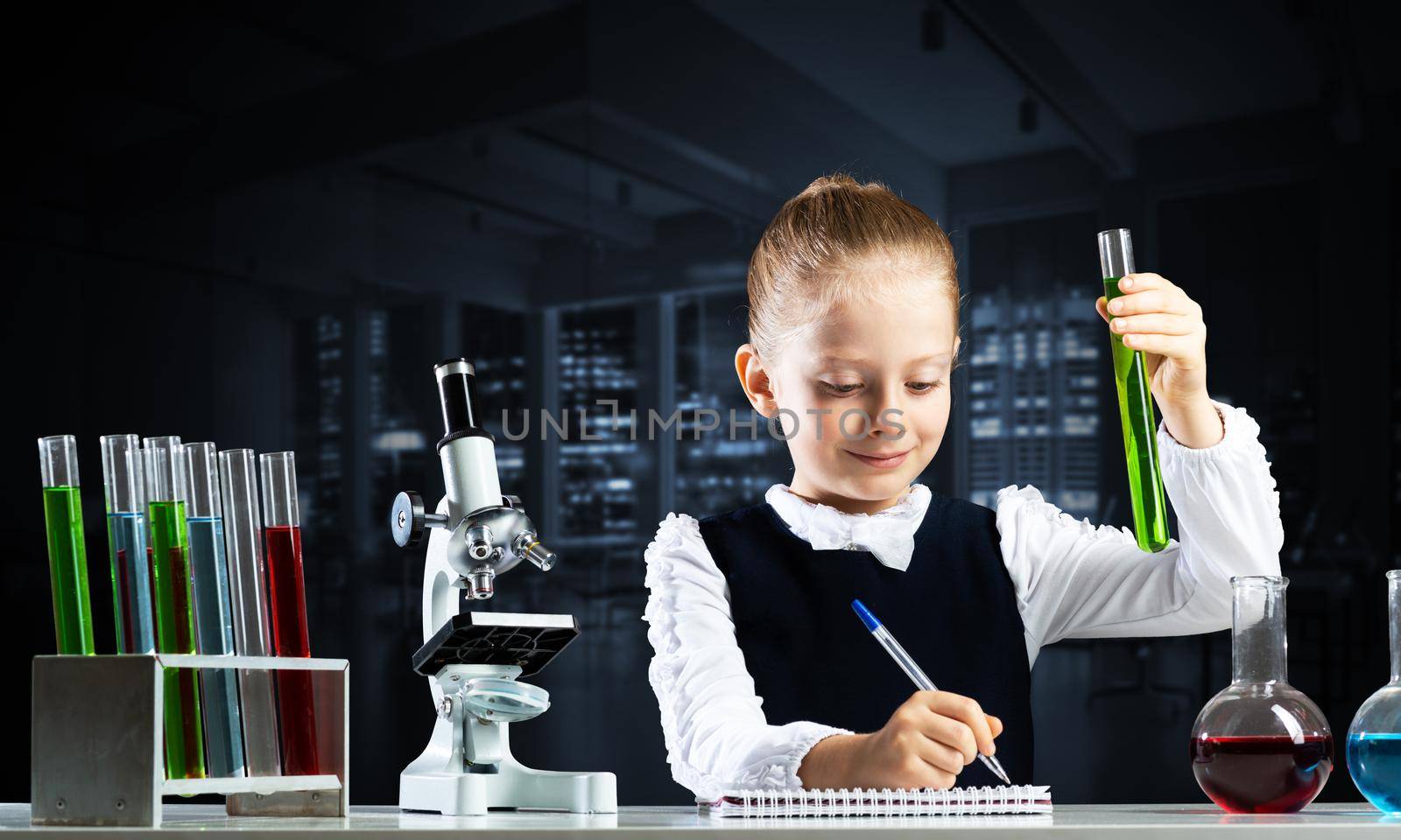 Little girl scientist with test tube writing in notebook. Research and education in school. Chemical laboratory with microscope and glass flasks. Schoolgirl making experiment in chemistry class.