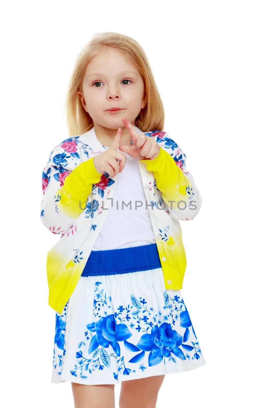 Pretty little blonde girl in a short summer skirt with Russian national ornament.