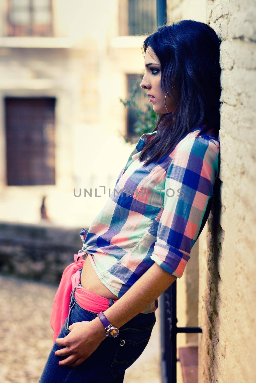 Portrait of a young beautiful woman in a urban background