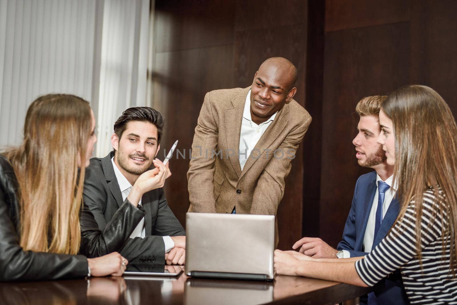 Businesspeople, teamwork. Group of multiethnic busy people working in an office