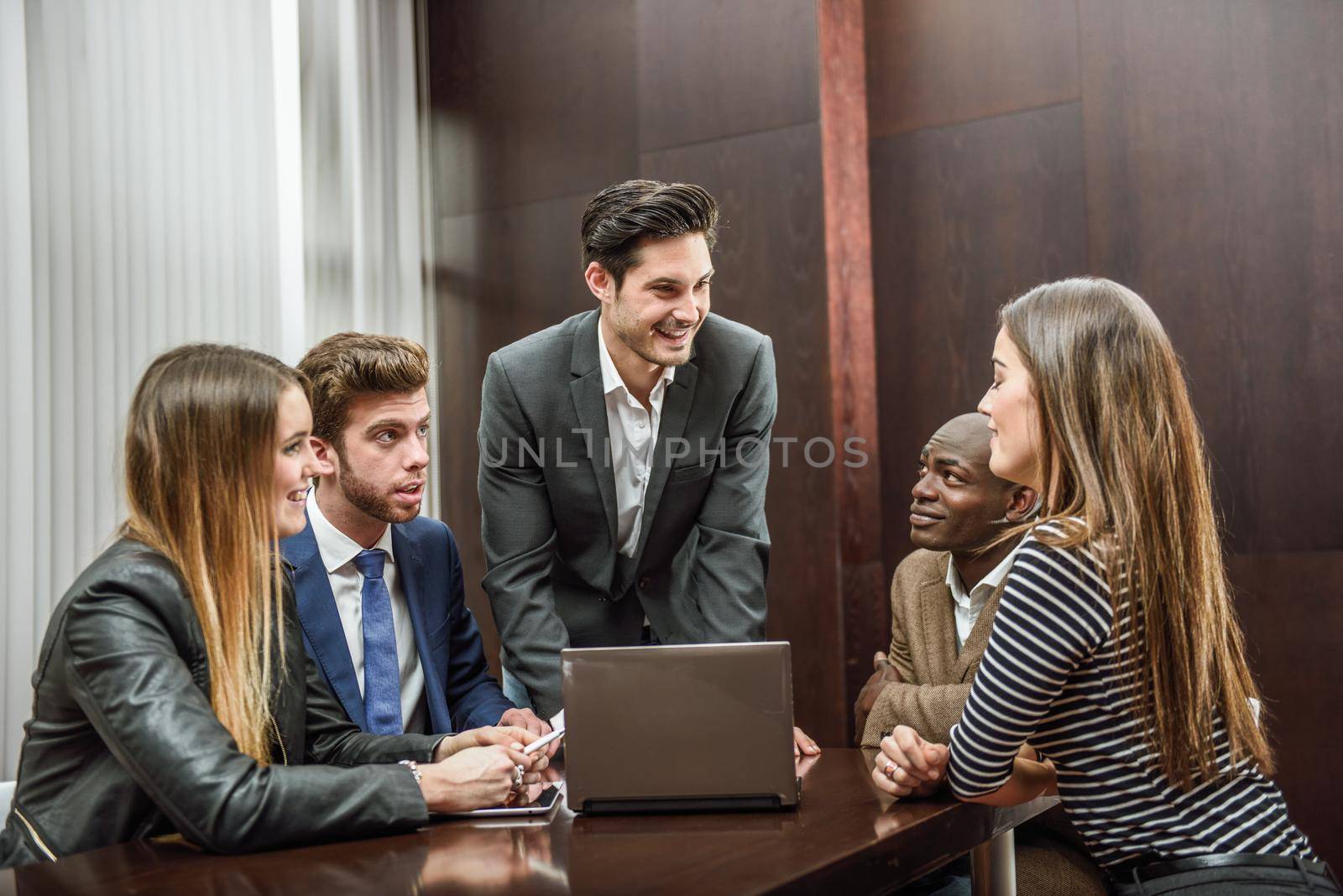 Businesspeople, teamwork. Group of multiethnic busy people working in an office