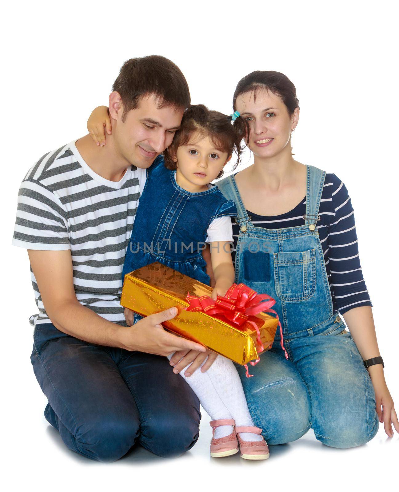Happy young family with little daughter cuddling together in celebration of Christmas.Isolated on white background.