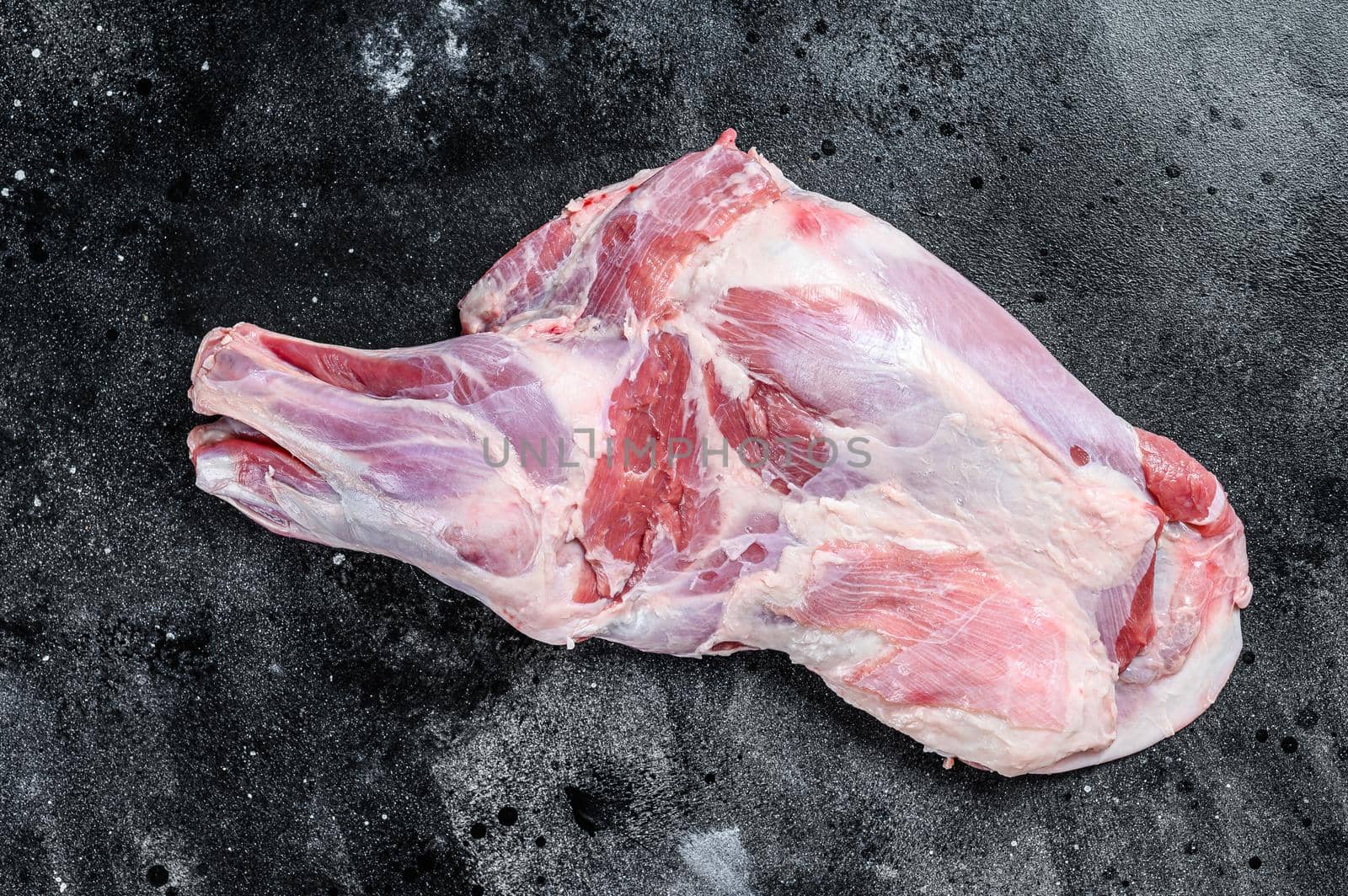 Raw lamb shoulder meat. Black background. Top view.