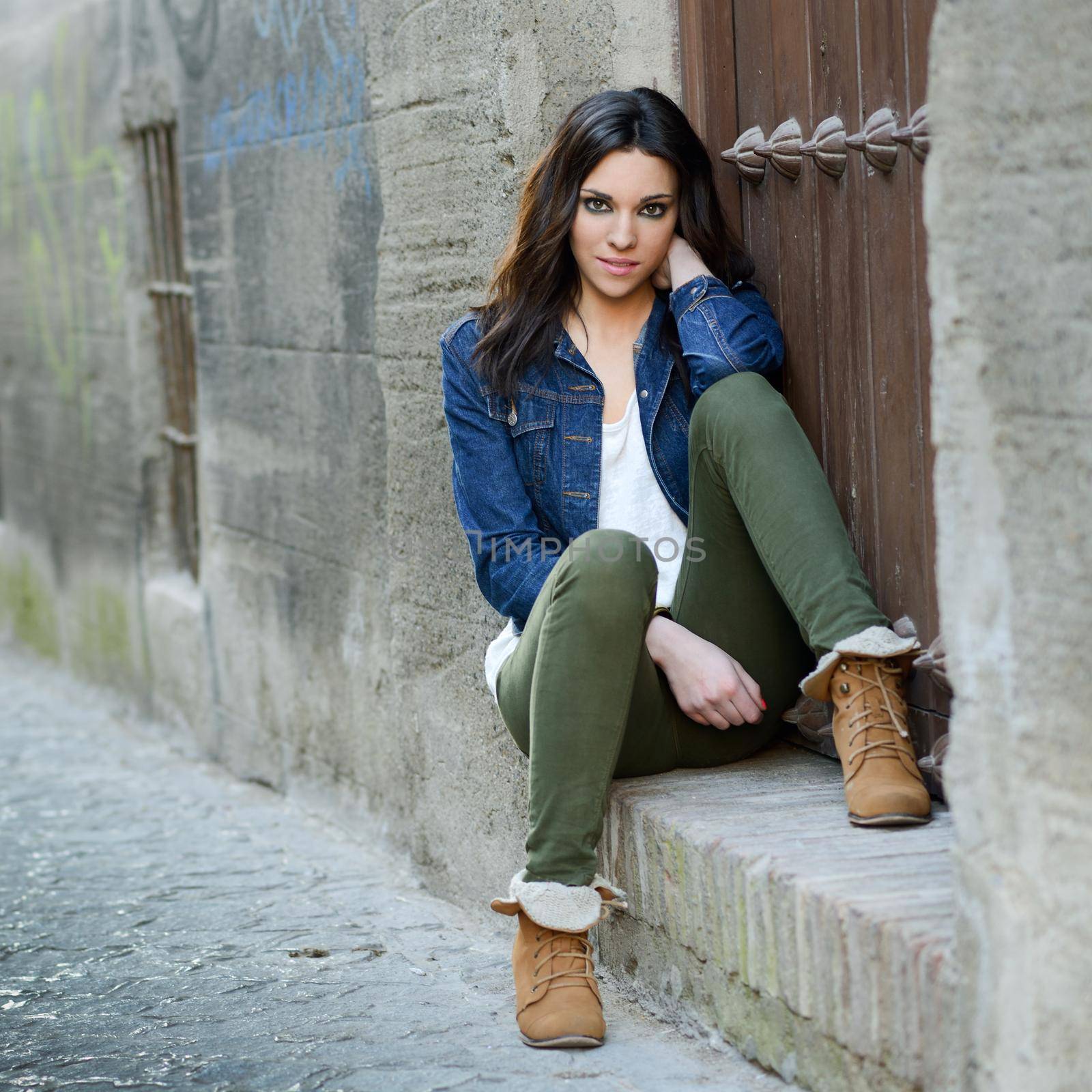 Portrait of a young beautiful woman in a urban background