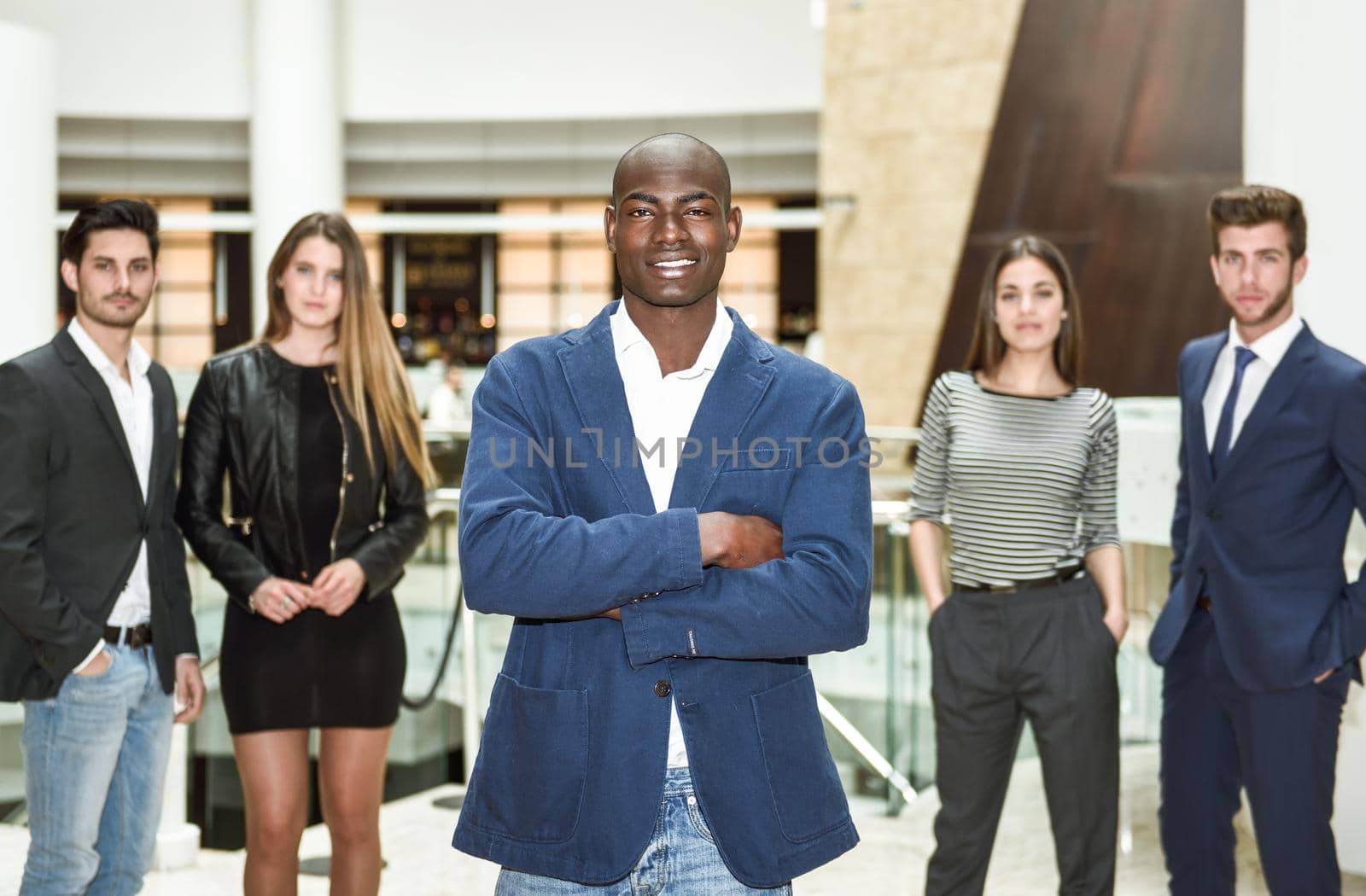 Cheerful young African man in formalwear keeping arms crossed by javiindy