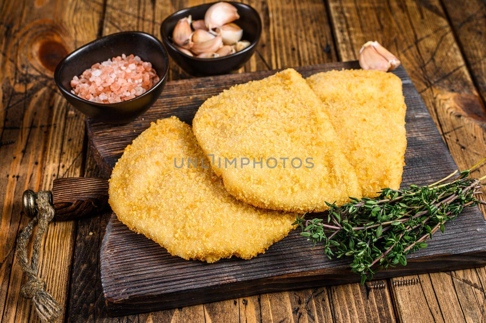 Cordon bleu meat cutlets with bread crumbs on a wooden board. wooden background. Top view by Composter