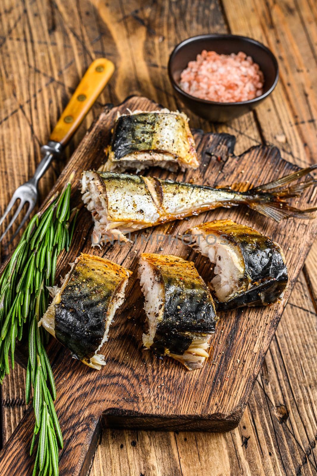 Grilled cut mackerel fish on cutting board. wooden background. Top view by Composter