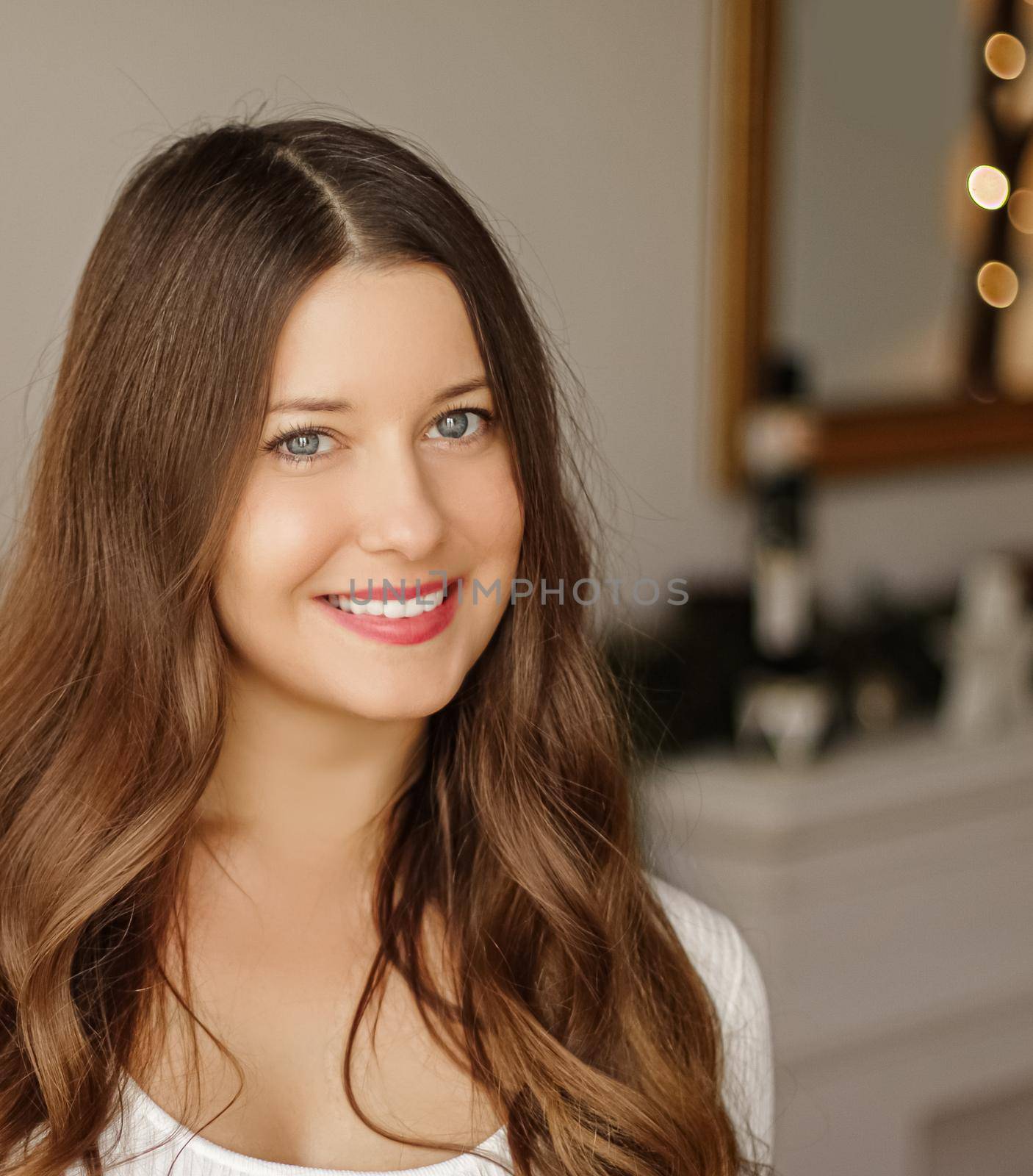 Christmas time and holiday mood concept. Happy smiling woman and decorated xmas tree lights on background.