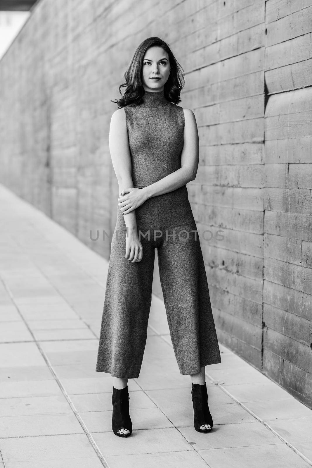 Beautiful young woman, model of fashion, in urban background