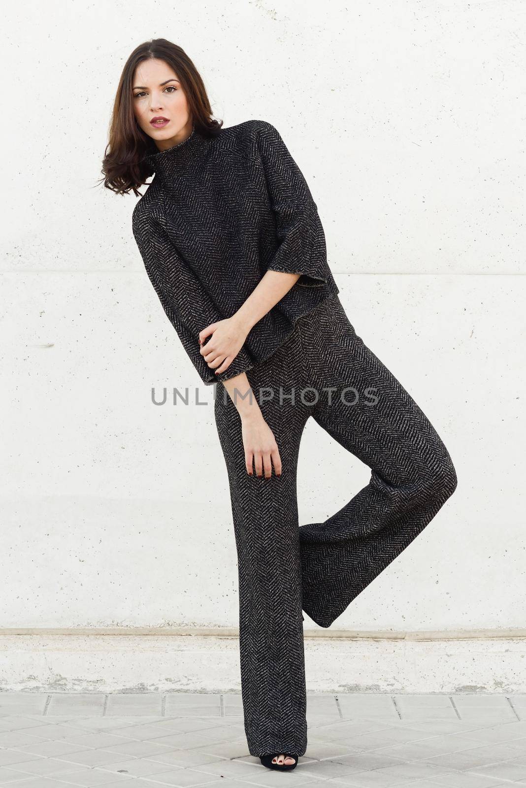 Beautiful young woman, model of fashion, in urban background