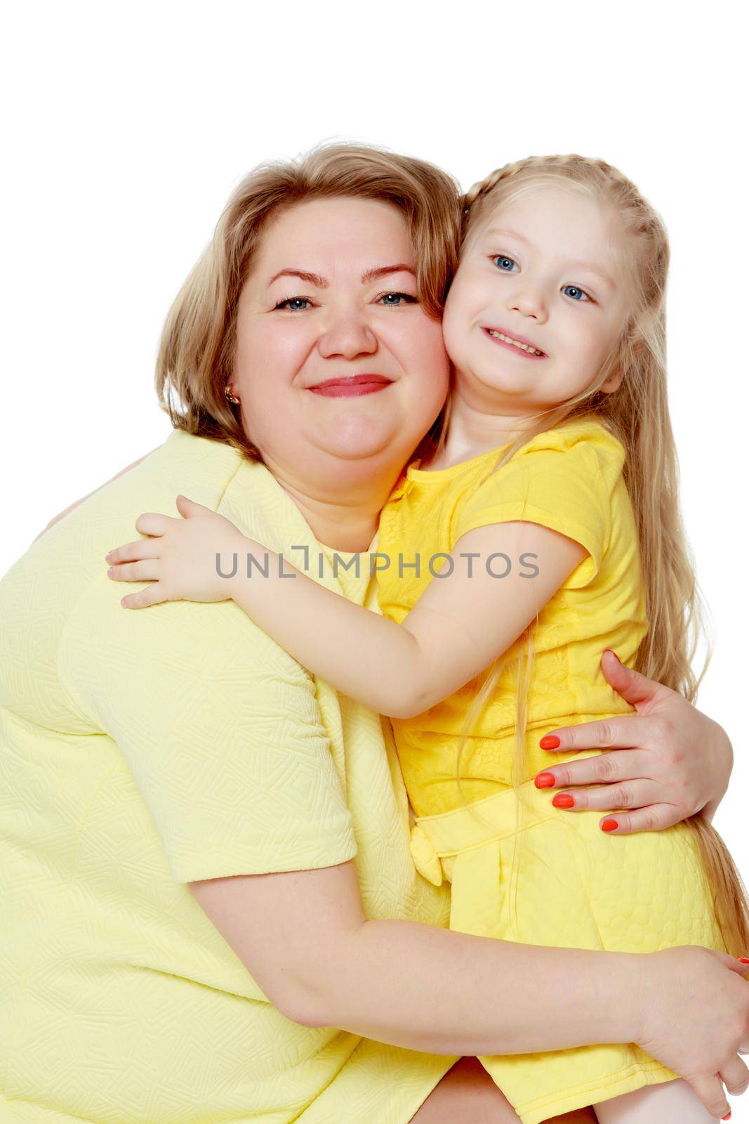 Young blonde mother, gently hugs her favorite little round-faced daughter. Family Idyll.Isolated on white background.