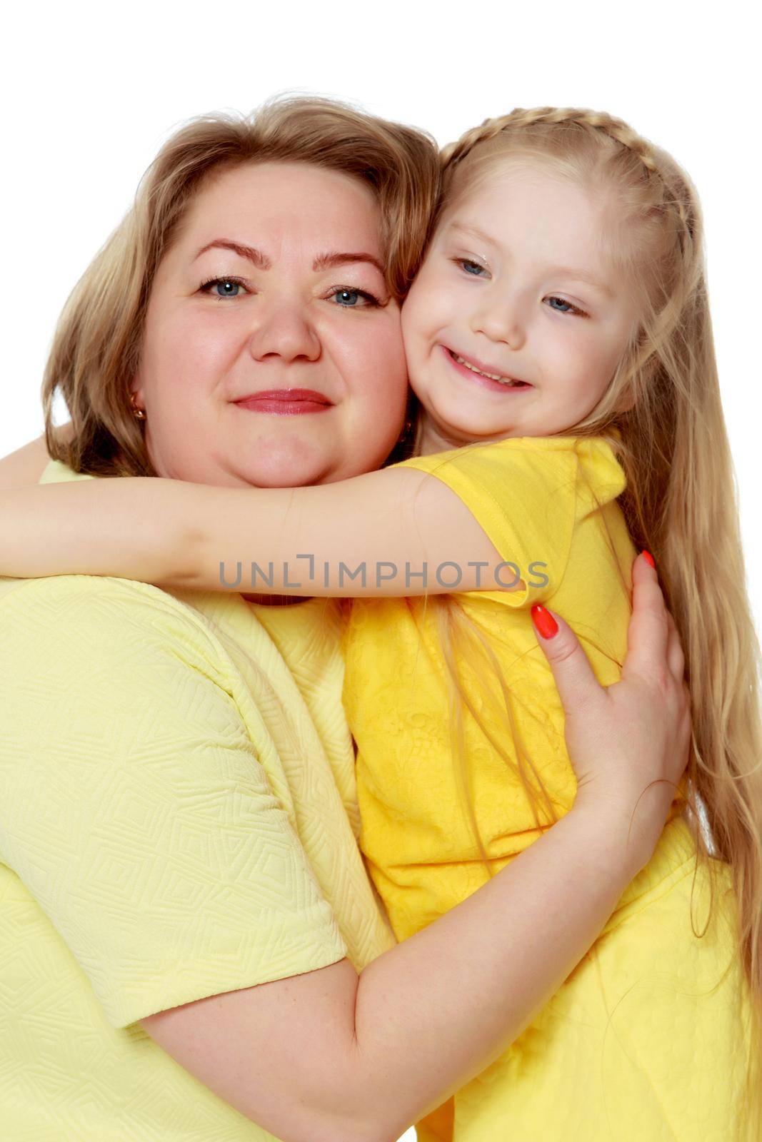 A happy mother hugs her beloved daughter. by kolesnikov_studio