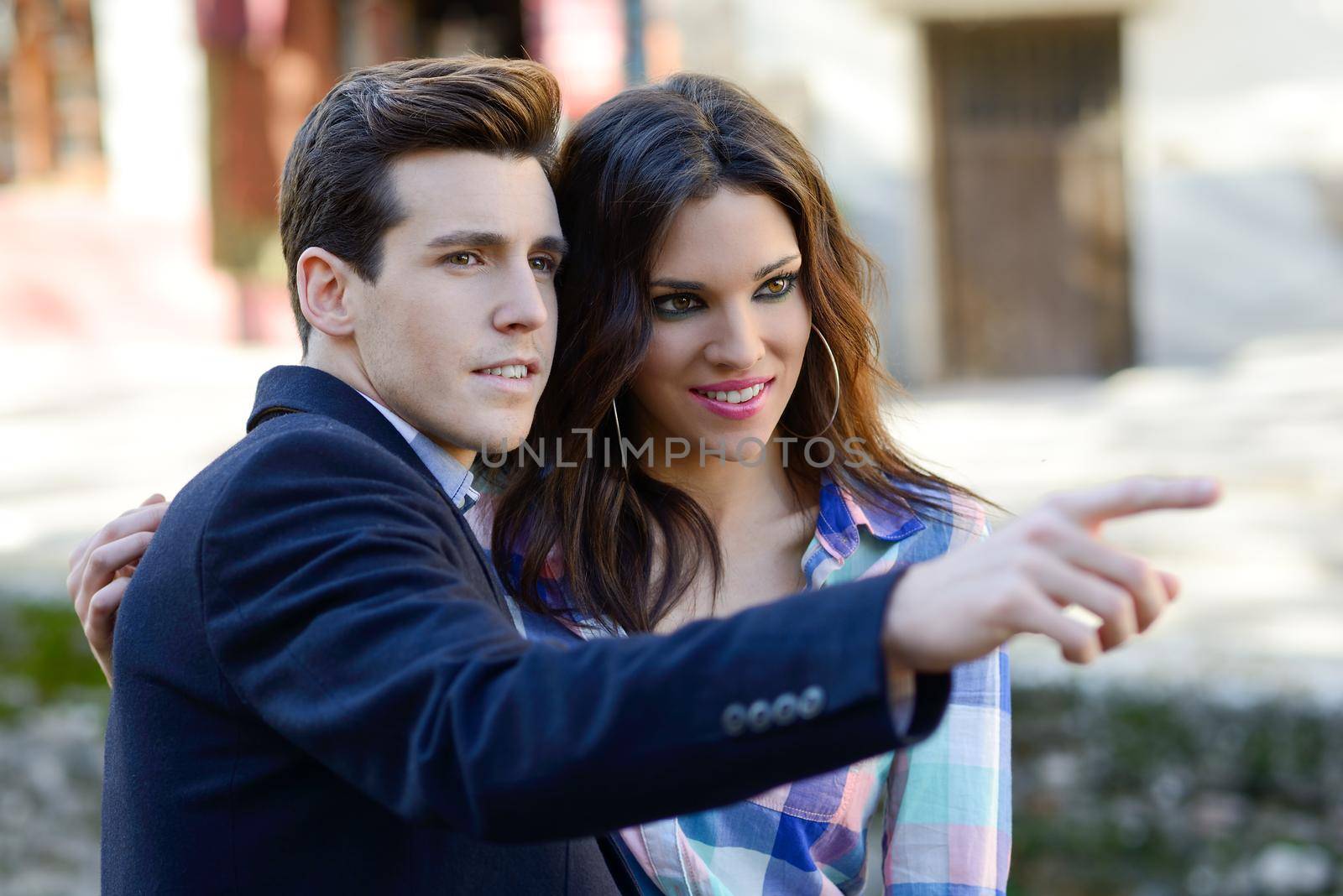 Portrait of a cheerful young couple on a city street