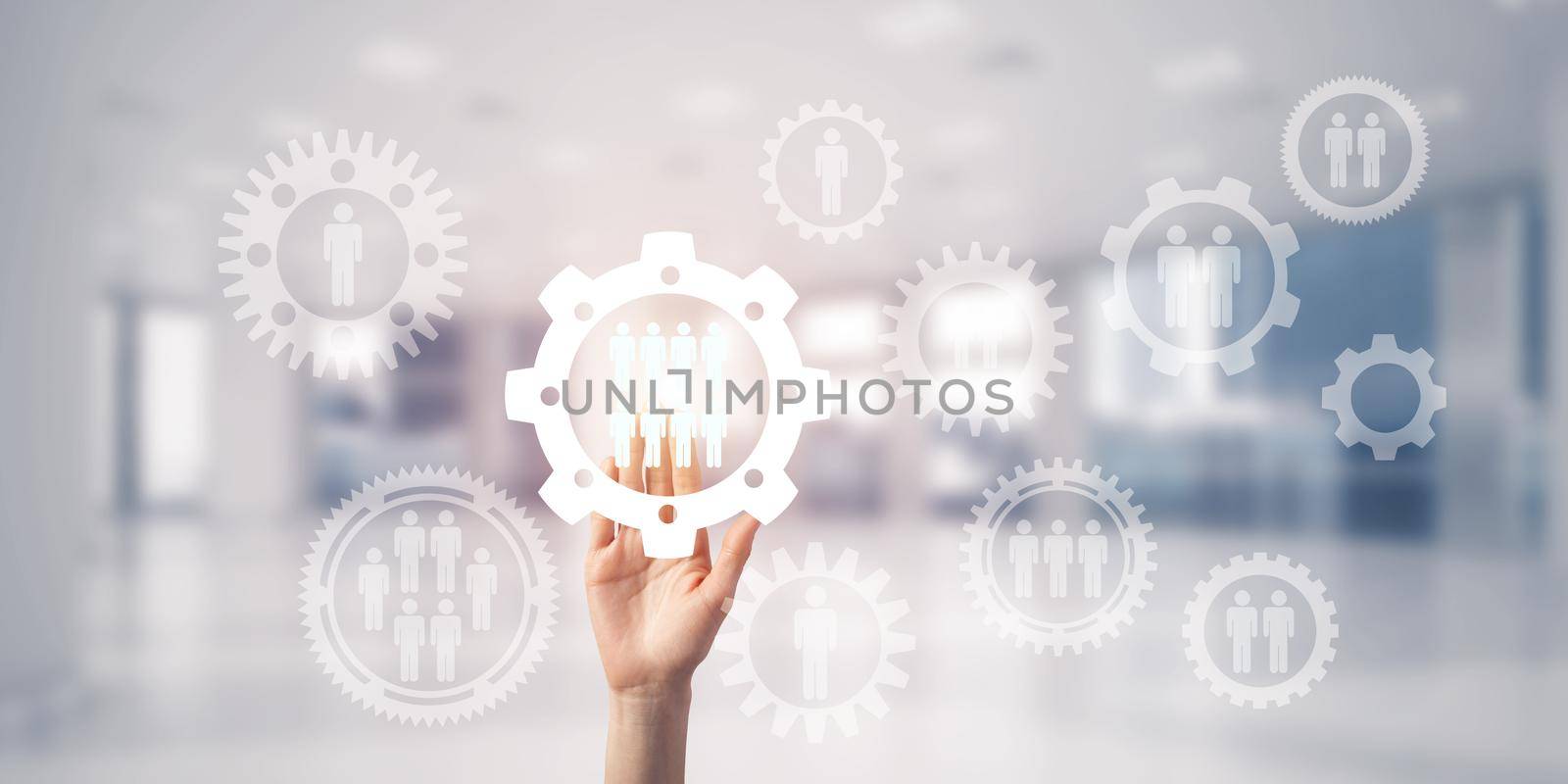 Close of woman hand touching gears on screen with palm and office at background