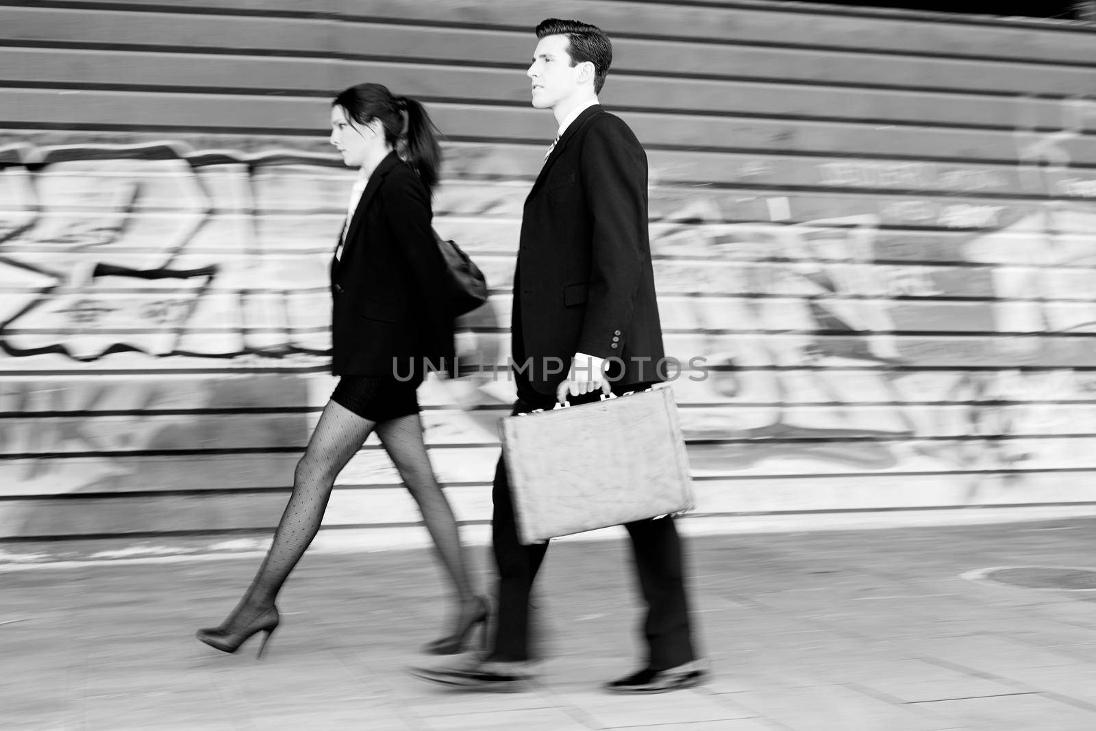 Business people walking in the street. Couple working by javiindy