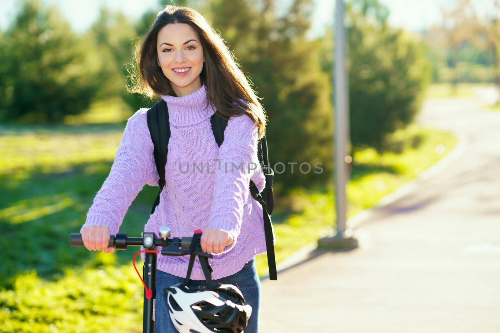 Young woman in her twenties riding an electric scooter. Lifestyle concept.
