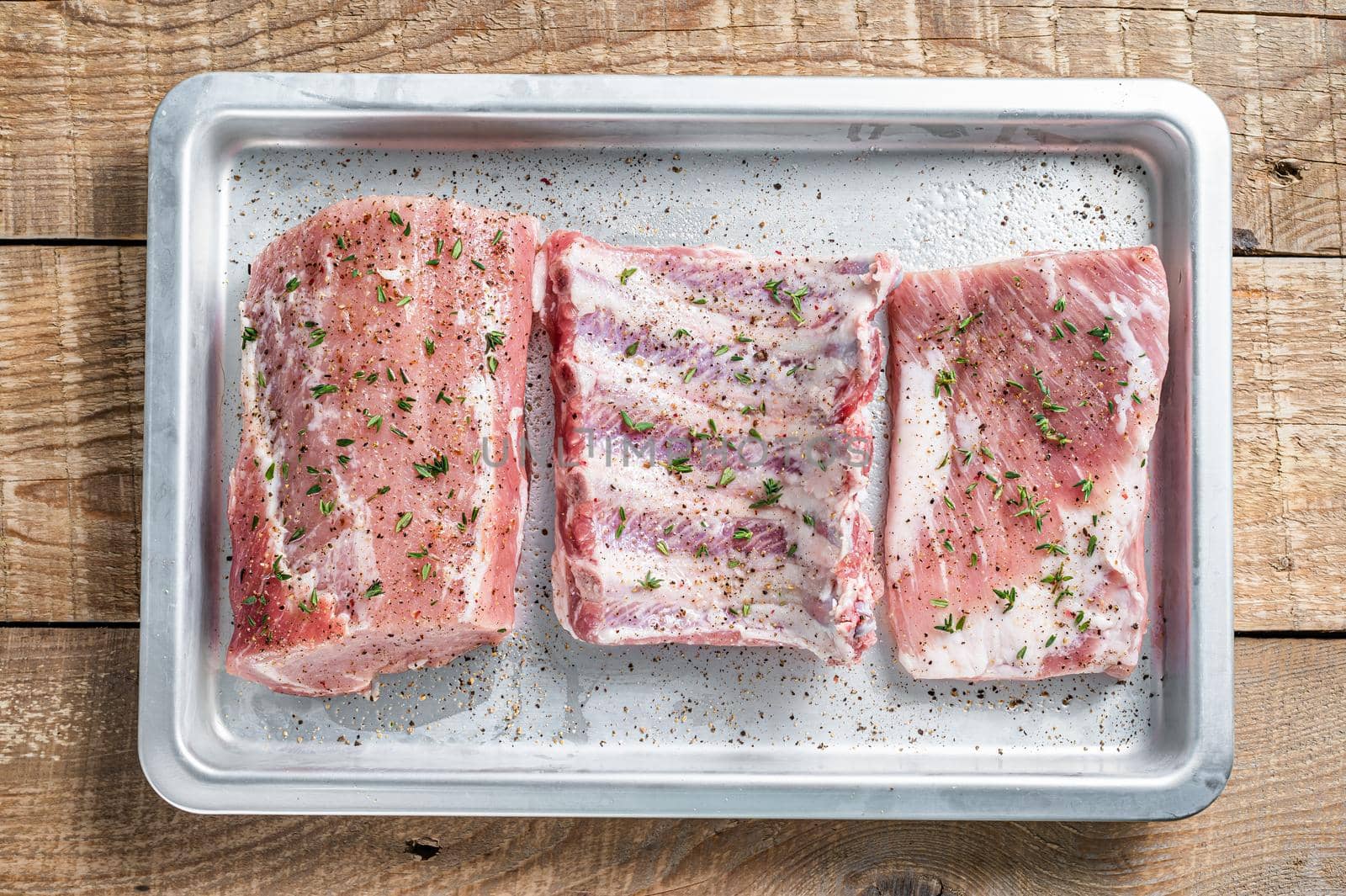 Set of Raw pork cuts, loin meat, spare ribs and brisket. Wooden background. Top view by Composter