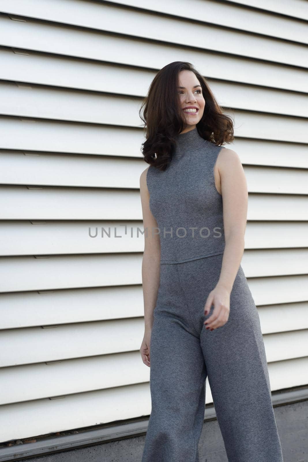 Young woman wearing casual clothes smiling in urban background. Girl with beautiful smile