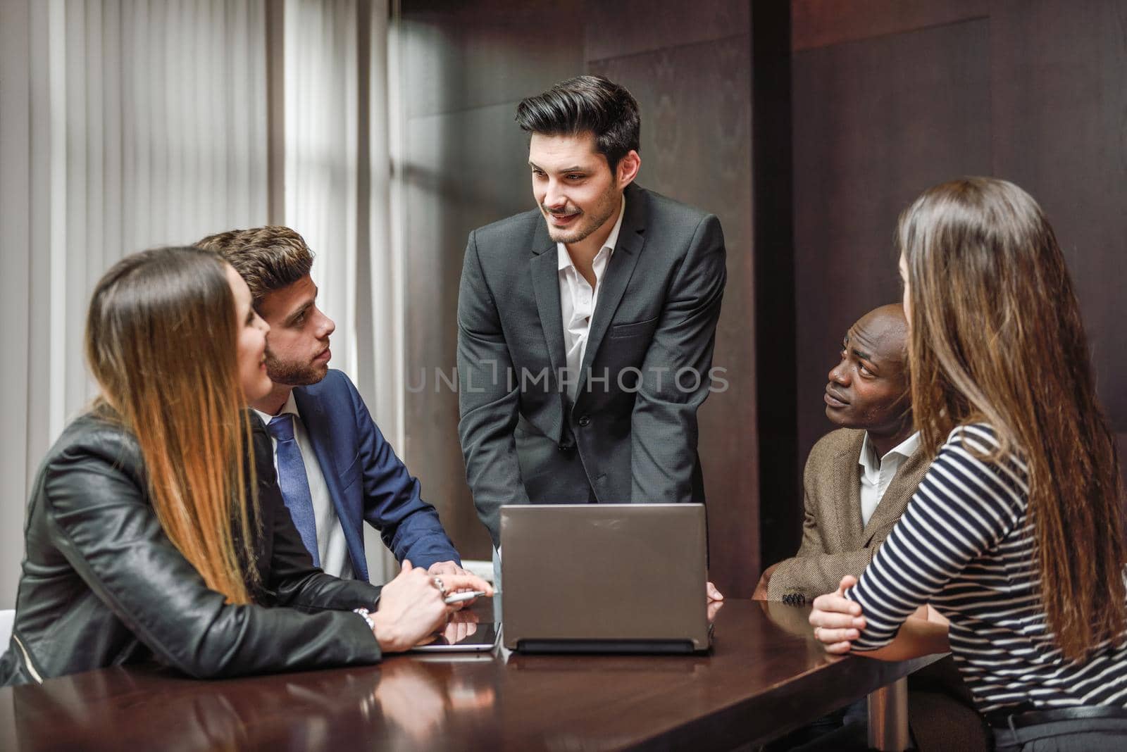 Businesspeople, teamwork. Group of multiethnic busy people working in an office