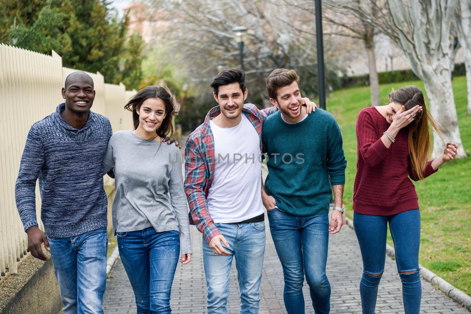 Group of friends having fun together outdoors by javiindy