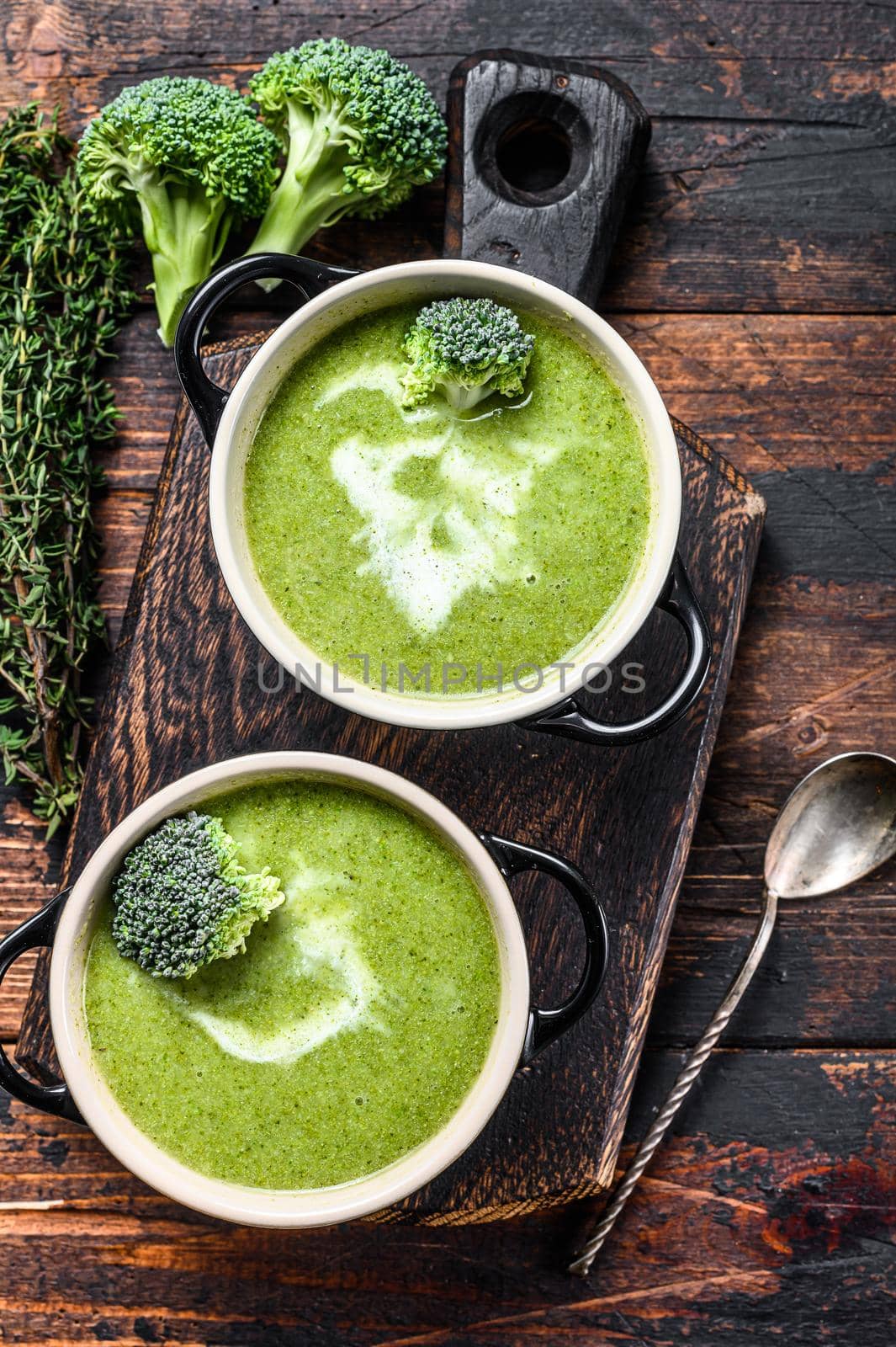 Fresh homemade cream broccoli soup in bowl . Dark Wooden background. Top view by Composter