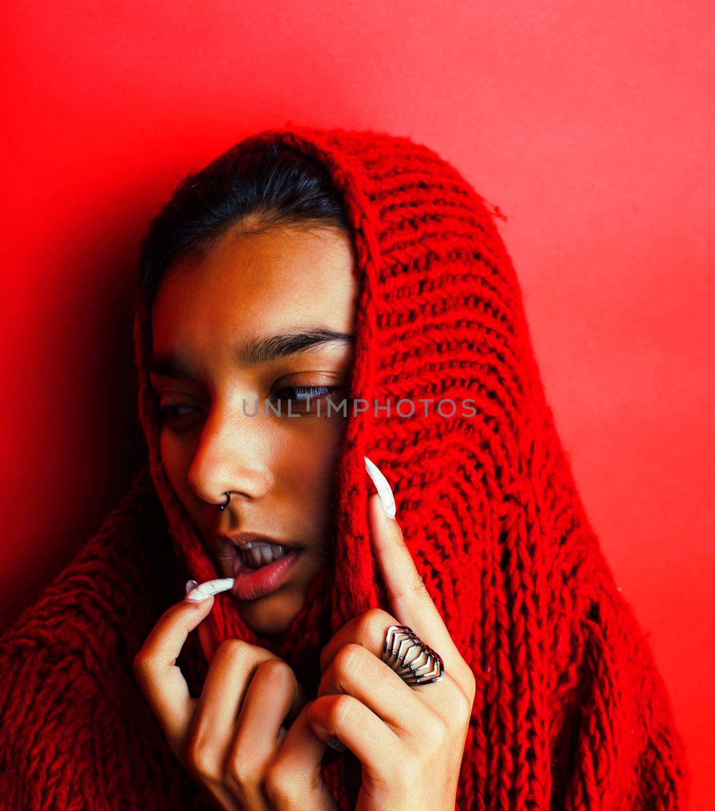 young pretty indian girl in red sweater posing emotional, fashion hipster teenage, lifestyle people concept closeup