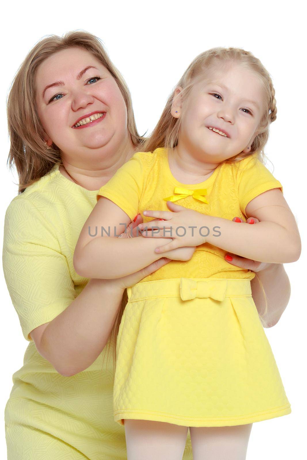 Young blonde mother, gently hugs her favorite little round-faced daughter. Family Idyll.Isolated on white background.