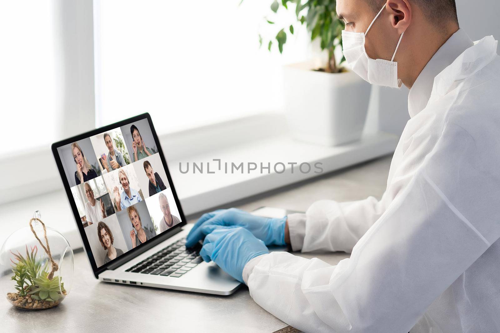 Doctor Having Video Conference On Laptop With Colleagues.