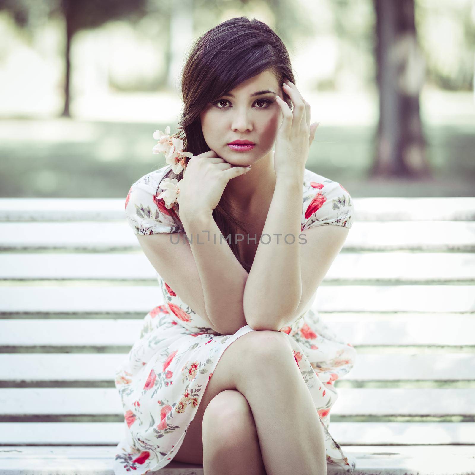 Close-up portrait of young beautiful japanese woman with pink and red flowers, model is an asian beauty