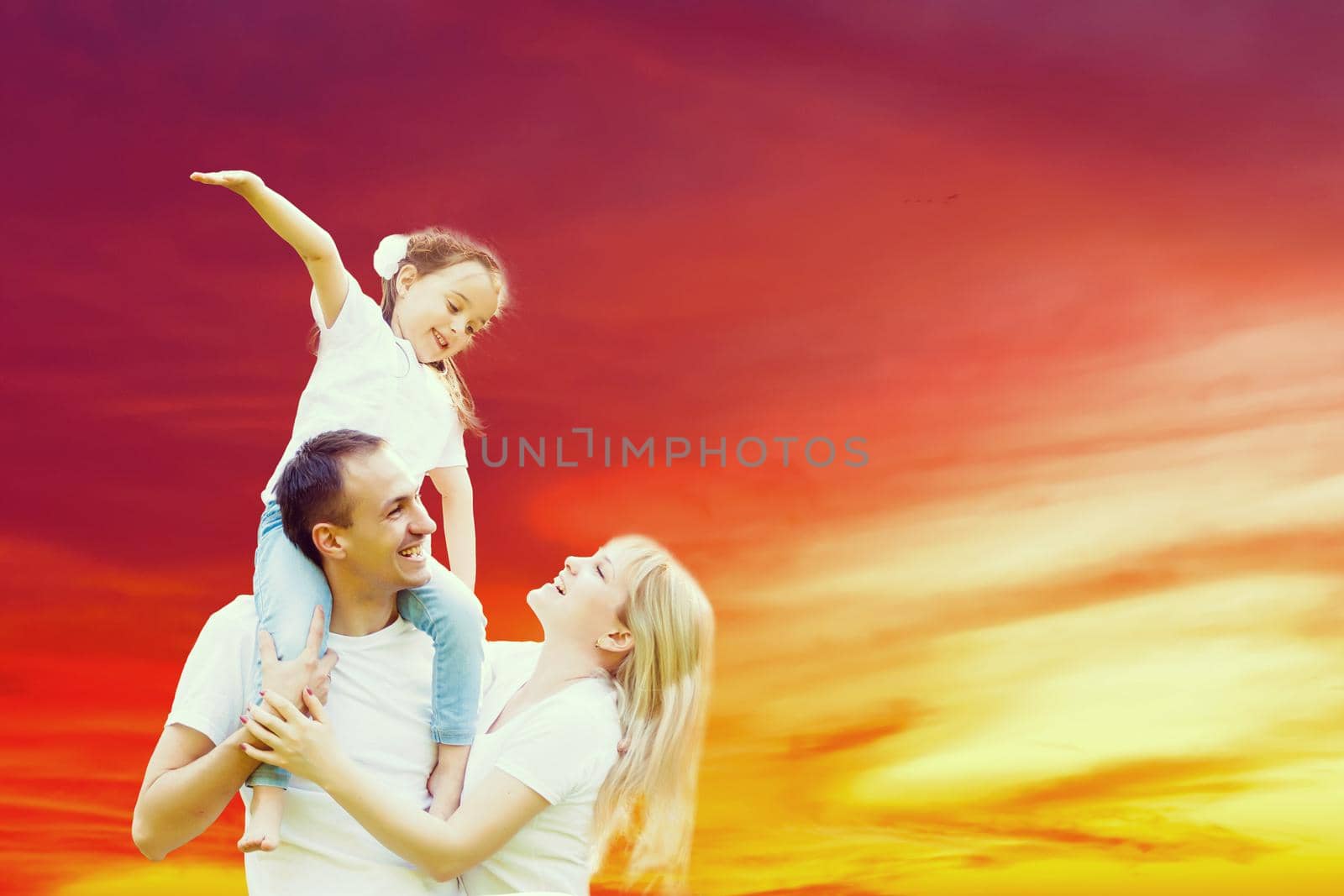 young happy family having fun outdoors, dressed in white and on sky and sunset by Andelov13