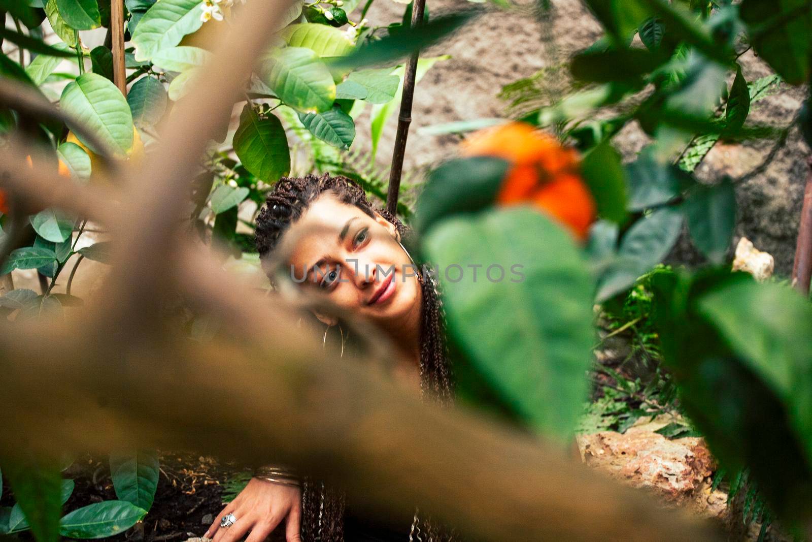 Young cute smiling woman in park with oranges, lifestyle concept green spring closeup