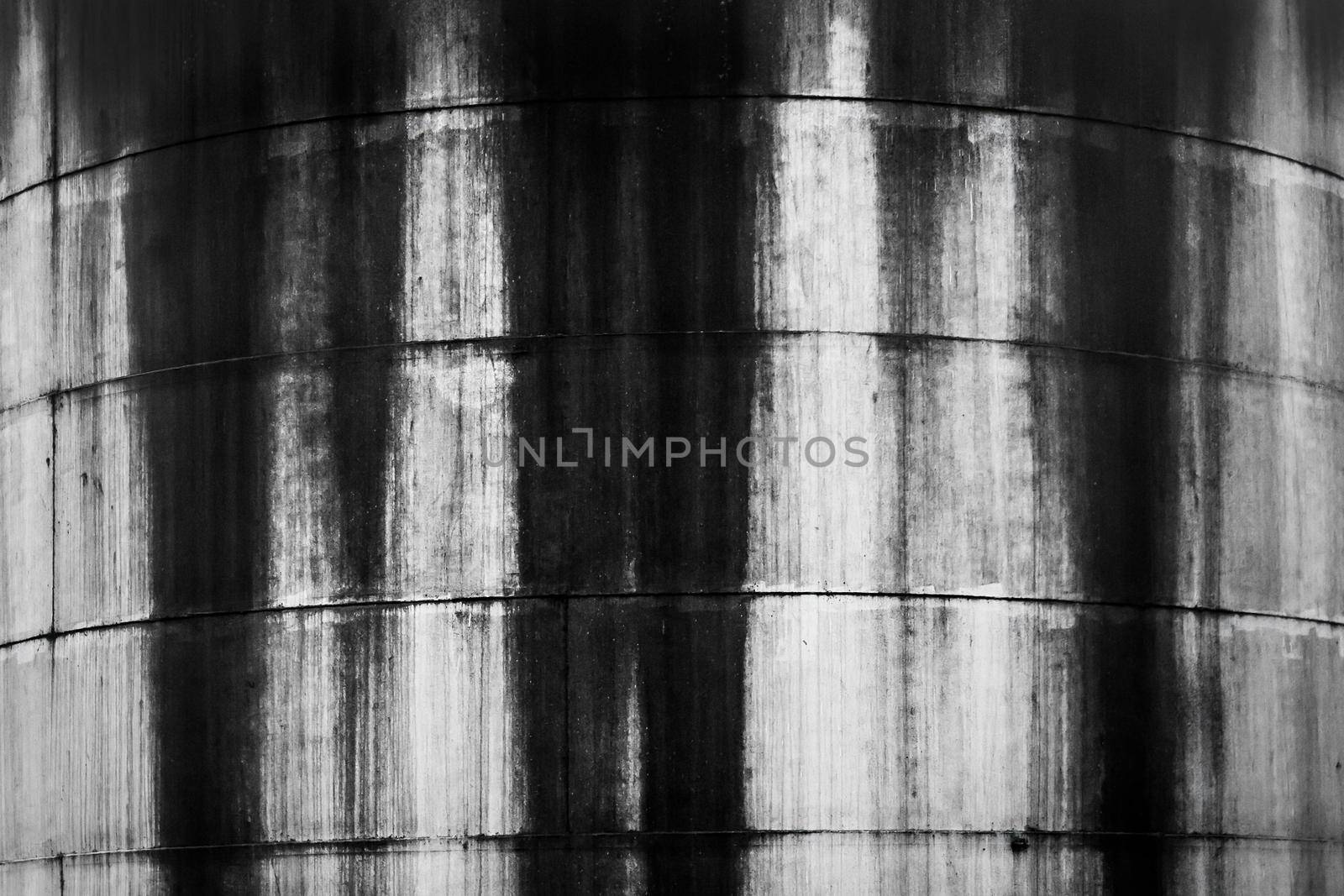 Old fuel tanks with fuel oil stains texture background at an abandoned industrial plant.